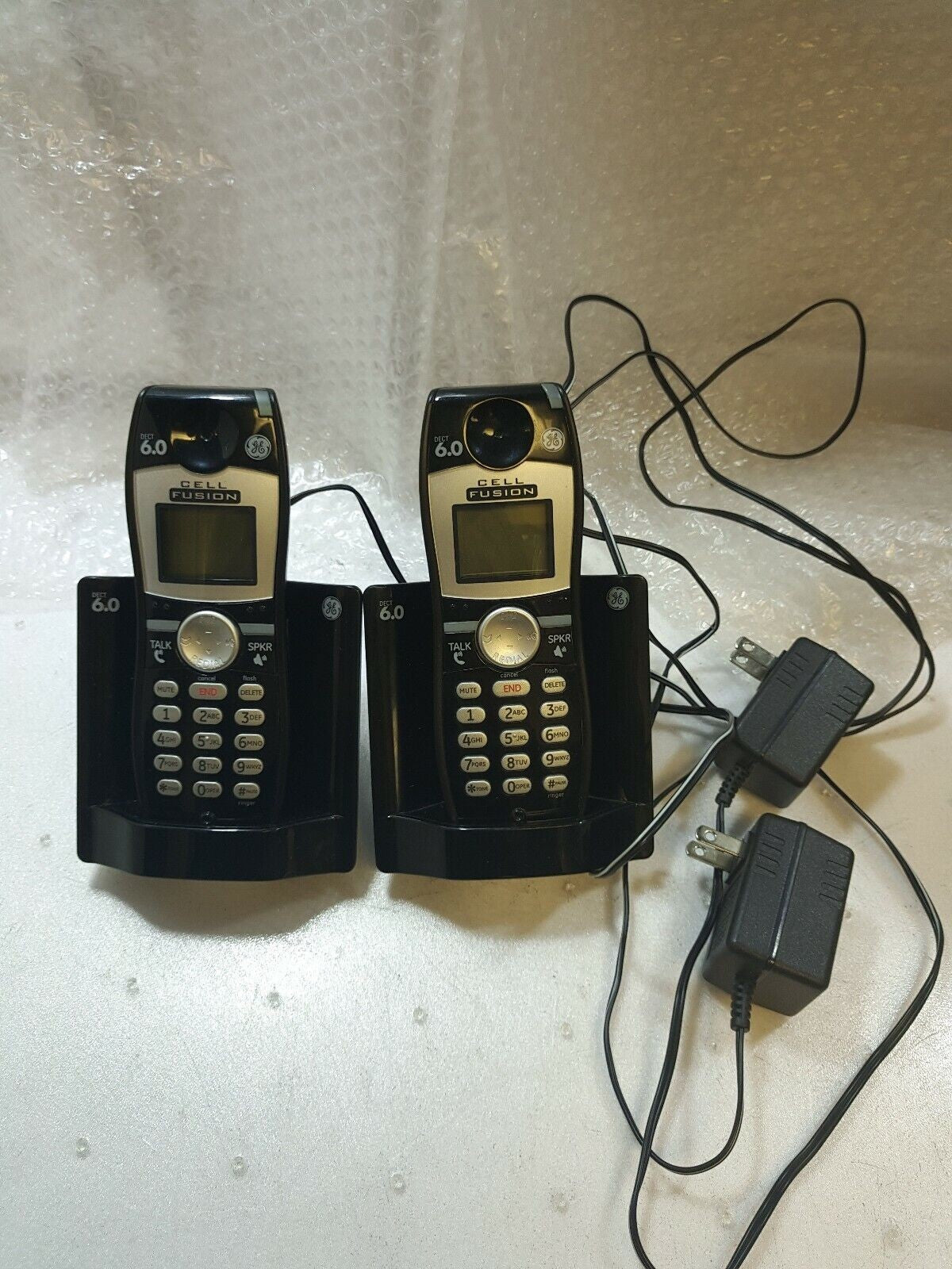 - 2x GE 6.0 DECT Cell Fusion Phones - (28127FE2-A) with Charger (Battery dead)