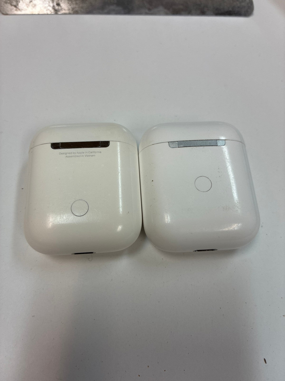 Lot of 2 Apple AirPods Lightning Charging Cases with one earbud